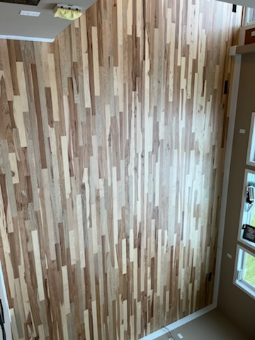 Custom accent wall of mixed-tone narrow wood strips